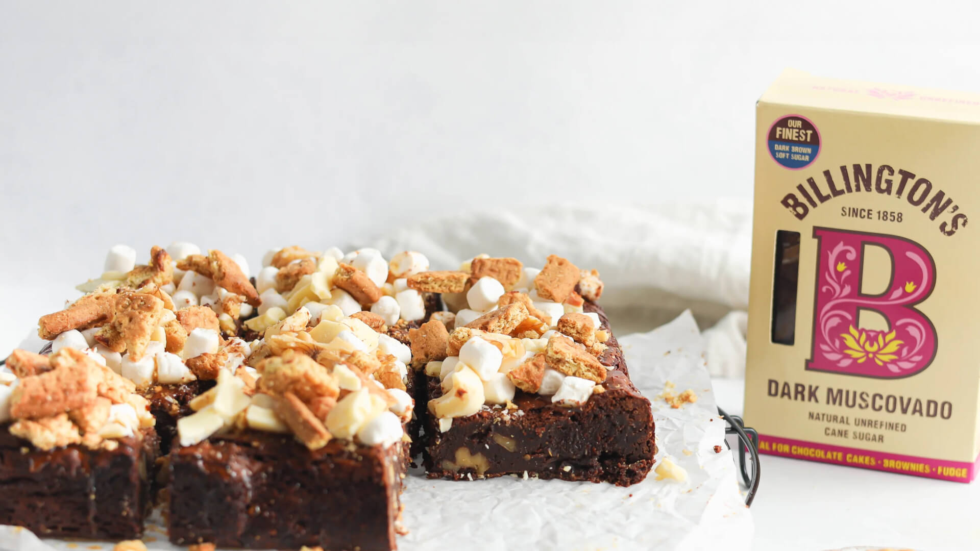A pack of Billington's Dark Muscovado Sugar next to a delicious looking traybake of rocky road brownies.